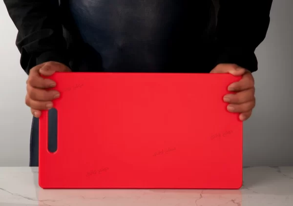 Sizing a red M37 cutting board against a Korean